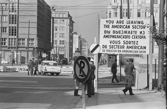 Checkpoint in West Berlin, West Germany with sign You are leaving the American Sector in four languages