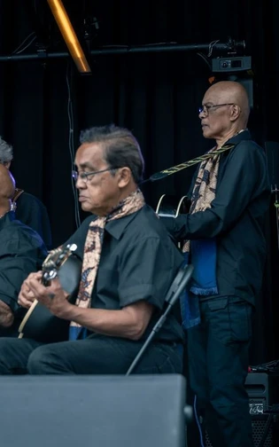 A band performing playing a song with instruments