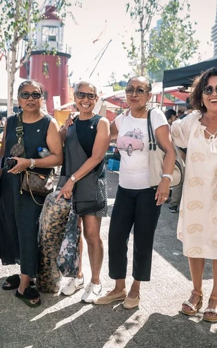 A group of people posting in front of the camera
