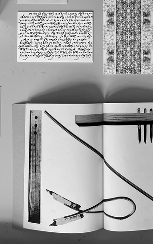 An open artist book surrounded by experimental handwritten and typographic works in black and white.
